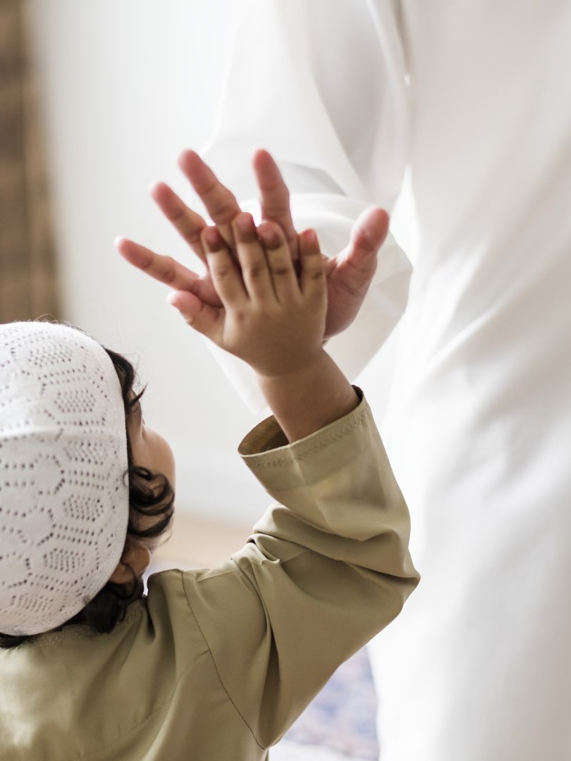 Muslim boy giving a high five
